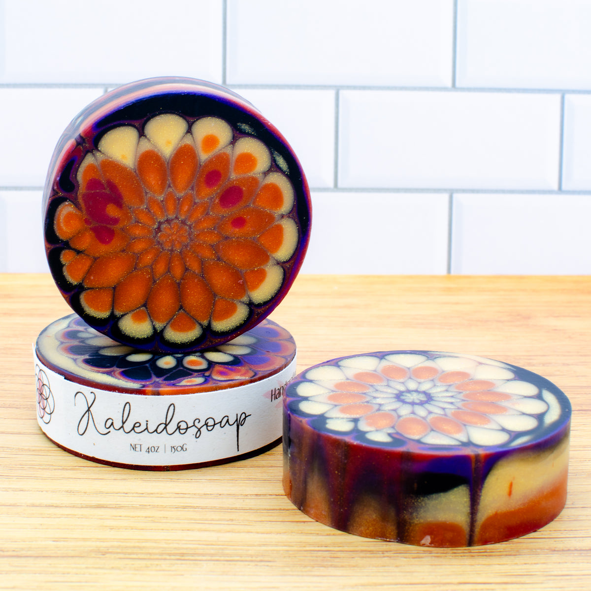 Kaleidosoap No. 29: one-of-a-kind soap in pumpkin orange, gold, purple, red, and black with gold shimmer (photo 3)