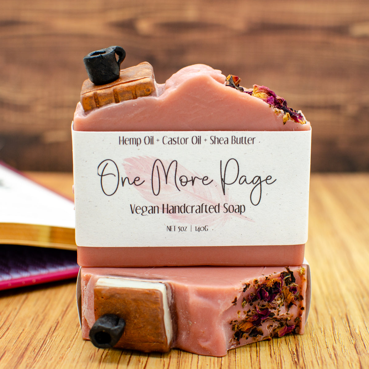 One More Page Soap: coffee and leather soap bar topped with a sculpted soap book, coffee cup, and rose petals